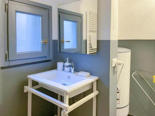a bathroom with a white sink and a mirror at Affittacamere Bernardo Ricci in Albenga