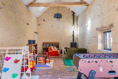 a room filled with lots of play equipment at La Garencière - La Petite Maison in Champfleur