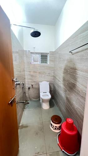 a bathroom with a toilet and a shower in it at Bakthapriya HILL VIEW RESIDENCY in Srikalahasti