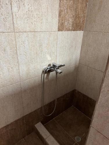a shower with a shower head in a bathroom at Cycladic Serenity Sunset View Home in Otziás