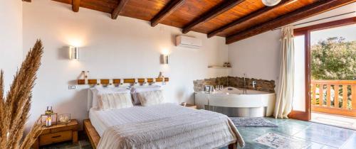 a bedroom with a bed and a tub and a sink at Villa Pia in Uta