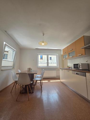 a kitchen with a table and chairs in a room at Apartmaji Pri Kokolu in Bled