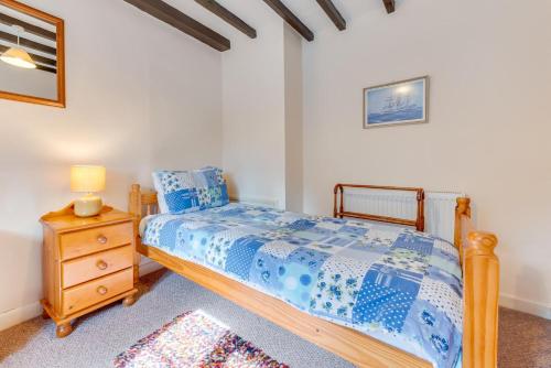 a bedroom with a wooden bed and a night stand at 3 Bed in Whitby oc-w009 in Whitby