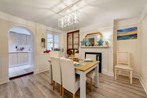 a dining room and kitchen with a table and chairs at 2 Bed in Appledore oc-s29561 in Appledore