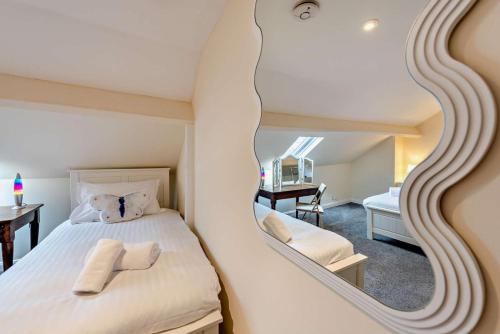 a bedroom with a large mirror above a bed at 2 Bed in Appledore oc-s29561 in Appledore