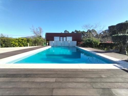 a swimming pool in a yard with a house at Casa de Santa Luzia in Vila Praia de Âncora