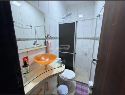 a bathroom with a bowl sink and a toilet at Condomínio Morada do sol in Barra Velha