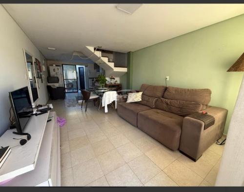 a living room with a couch and a table at Condomínio Morada do sol in Barra Velha