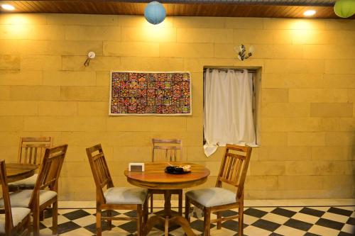 a dining room with a table and chairs at Desert Popular Resort & Camp in Jaisalmer