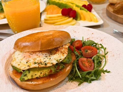 een bord met een broodje kip en een salade bij VILLTAK La Maison - Adults Recommended Only in Marbella