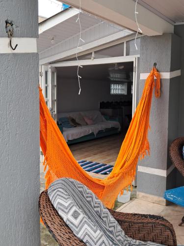 an orange hammock in a room with a bedroom at Oásis Xangri-lá in Xangri-lá