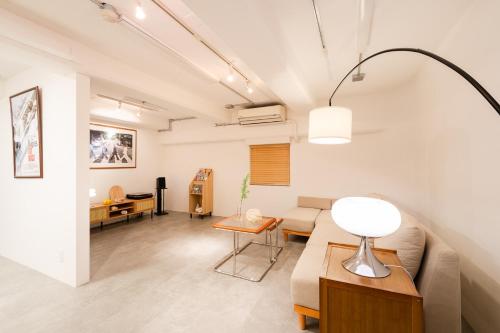a living room with a couch and a table at Shibuya Beatles house 10min walk from Shibuya Station in Tokyo