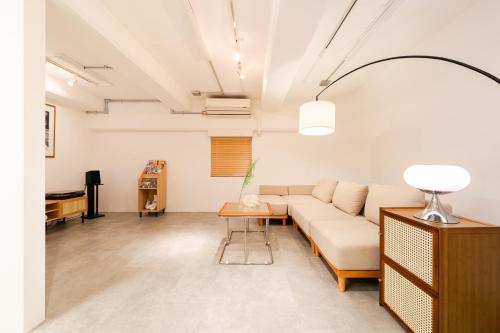 a living room with a couch and a table at Shibuya Beatles house 10min walk from Shibuya Station in Tokyo