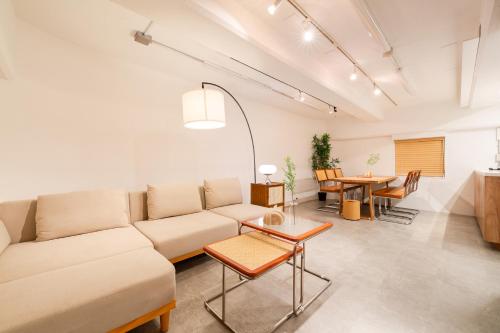 a living room with a couch and a table at Shibuya Beatles house 10min walk from Shibuya Station in Tokyo