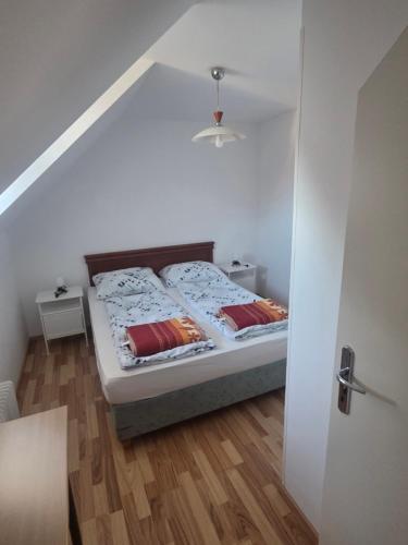 a bedroom with a bed with two pillows on it at Apartmaji Pri Kokolu in Bled