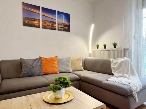 a living room with a couch and a table at Home4You Szombathely in Szombathely