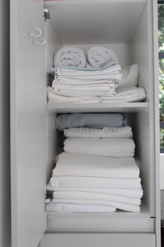 a stack of folded towels in a closet at Tash's Place in Roodepoort