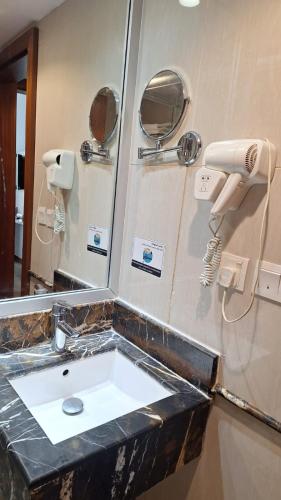 a bathroom with a sink and a mirror at Sunrise Ajyad Hotel in Mecca