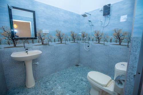 a bathroom with a toilet and a sink and a mirror at Breeze Heavens Yala in Polgahawelana