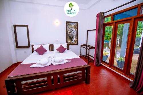 a bedroom with a bed with two towels on it at Breeze Heavens Yala in Polgahawelana