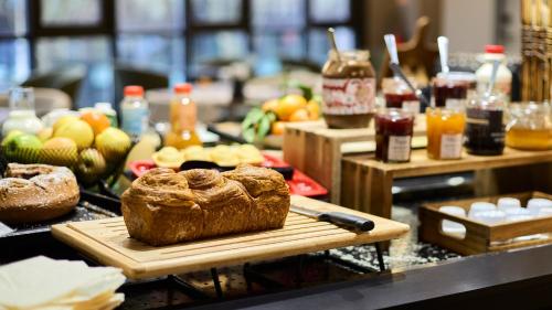 una tavola con una pagnotta di pane su un tagliere di Campanile PRIME - Arcueil ad Arcueil
