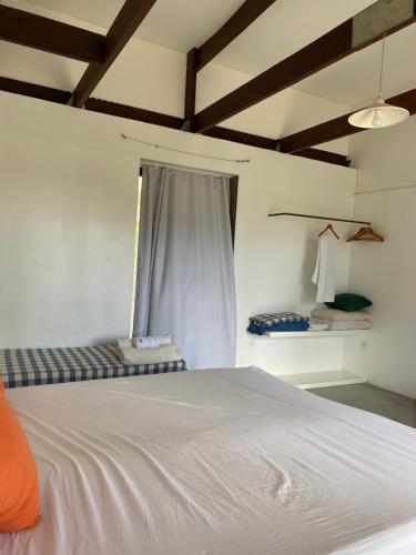 a bedroom with a white bed and a window at Coco Ville SMG in São Miguel do Gostoso