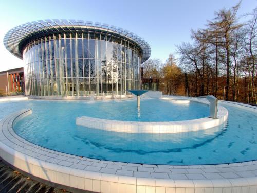 a large pool of water in front of a building at Villa Sparadis in Spa
