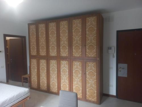 een kamer met een grote houten kast en een bed bij Residenza Caniana in Torre Boldone