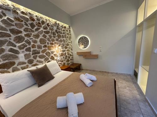 a bedroom with a large bed with towels on it at Alkionis Garden View Apartments in Lefkada