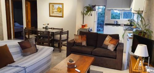 a living room with a couch and a table at Casa en Punta Colorada con gran fondo y fogón in Punta Colorada