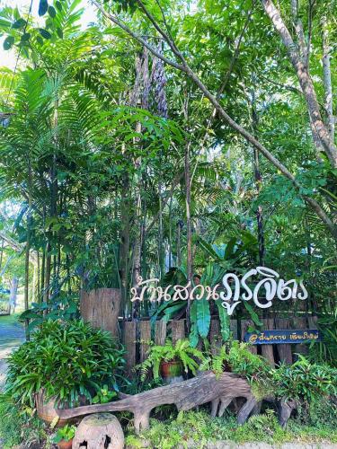 a bench in front of a forest of trees at บ้านสวนภูรจิตร Baansuanphurajit in Ban Nong Pa Kha