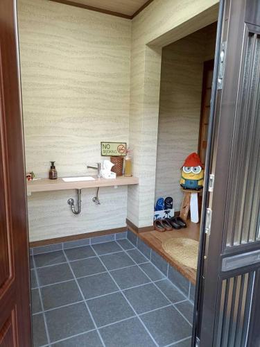 a bathroom with a sink and a tile floor at つるふく in Misaki