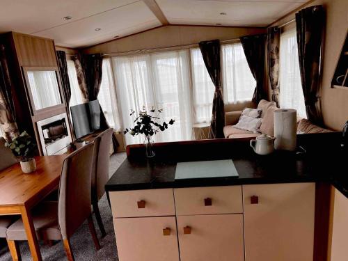 a kitchen and dining area of an rv at Peaceful Whitley Bay Getaway with Shared Indoor Pool in Whitley Bay