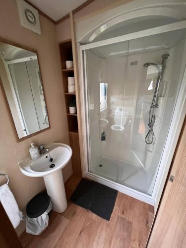 a bathroom with a shower and a sink at Peaceful Whitley Bay Getaway with Shared Indoor Pool in Whitley Bay