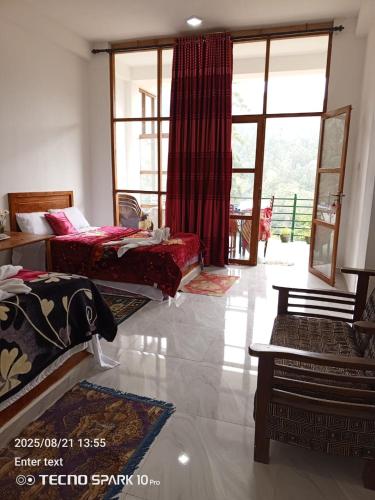 a living room with two beds and a large window at Hilltop Panorama Ohiya in Ohiya