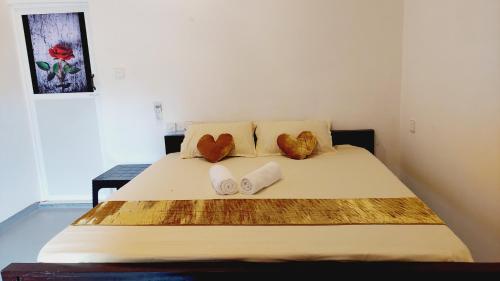 a bedroom with a bed with two towels on it at Econest arugambay in Arugam Bay