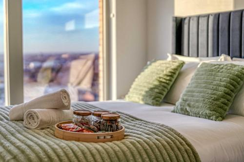 a bed with a tray of food on top of it at 2-BR Flat - City & Town Centre View -1 Minute to Train & Tram Station - Sleeps 5 in Manchester