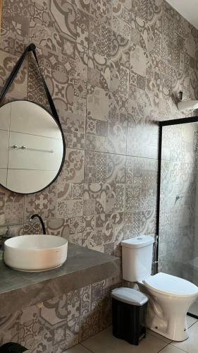 a bathroom with a sink and a toilet at Espaço verão in Santa Fé do Sul