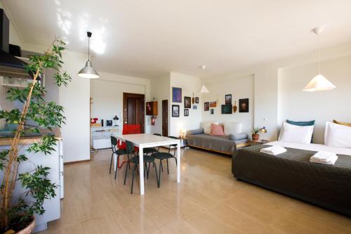 a living room with a couch and a table at Casa Guilhermina, Sunny Studio with Balcony in Porto