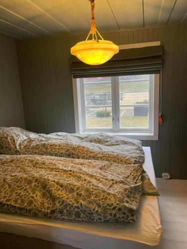 a bedroom with a bed and a window at Apartment at NerSalberg Farm in Røra, Inderøy in Røra