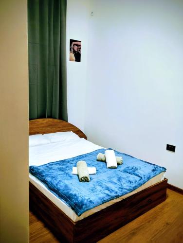 a bedroom with a bed with towels on it at GuestHouse5 KARMA369 in Plovdiv