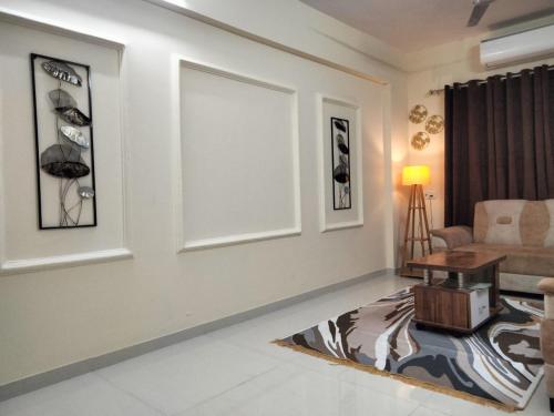 a living room with a couch and a table at Sunset stay in Daman