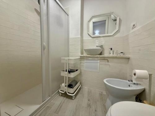 a white bathroom with a sink and a toilet at Lake Suite in Trevignano Romano
