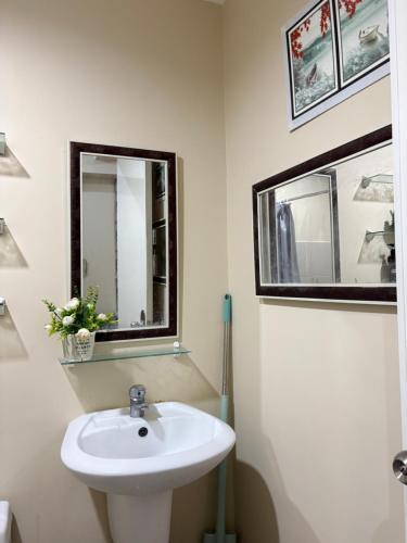 a bathroom with a sink and a mirror at Avida Aspira Tower 1 - Chads Unit 8th Floor in Cagayan de Oro