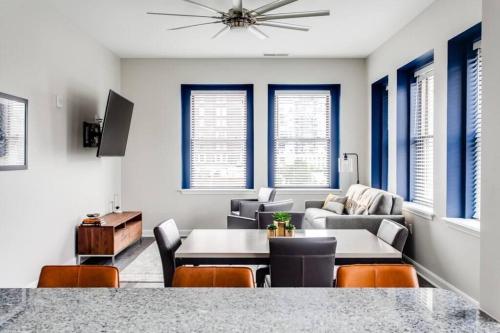 a living room with a couch and a table and chairs at Historic Elegance Modern Amenities Gym in Louisville