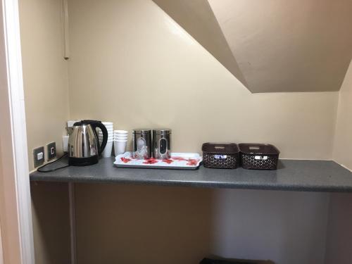 a counter top with some appliances on it at Anfield Accommodation part of The Twelfth Man Public House in Liverpool