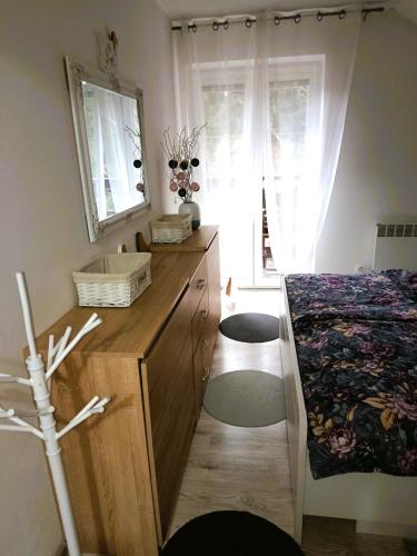 a bedroom with a dresser and a bed and a mirror at Apartmán Romanna in Terchová