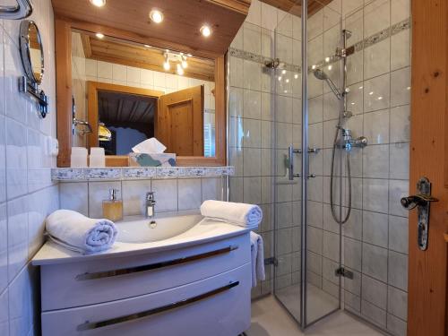 a bathroom with a sink and a shower at Ferienhaus Alpenzauber in Krün