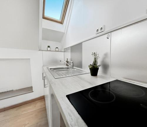 a kitchen with a sink and a counter top at Central, spacieux et calme votre cocon à Melun in Melun