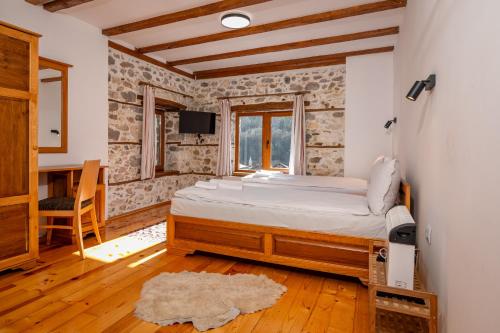 a bedroom with a bed and a table and a window at Villa Martina in Smilyan